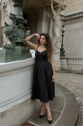 a lady wears a black spaghetti strap midi dress